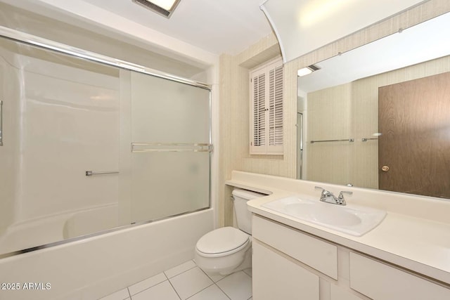 bathroom with visible vents, toilet, enclosed tub / shower combo, vanity, and tile patterned flooring