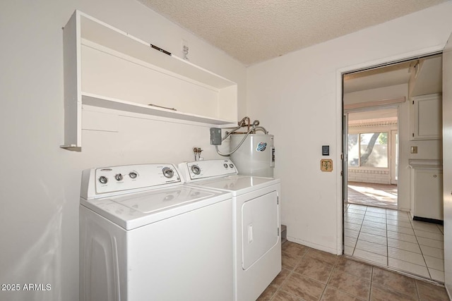 laundry area with a textured ceiling, light tile patterned flooring, washing machine and dryer, electric water heater, and laundry area