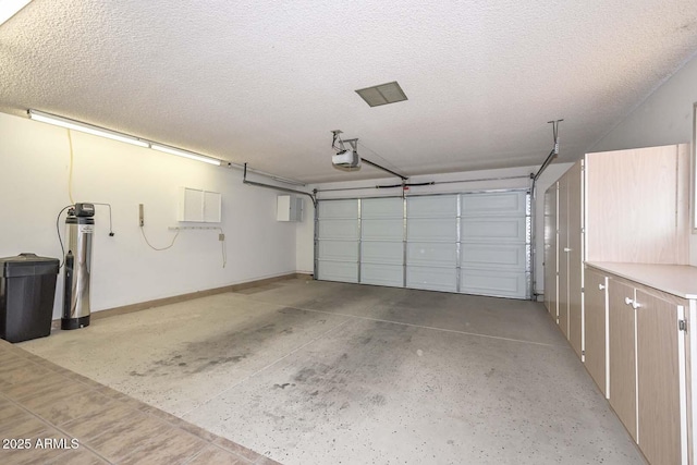 garage featuring baseboards and a garage door opener