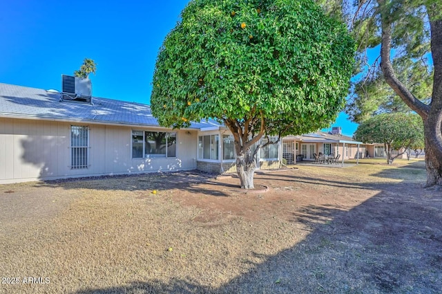 back of house featuring central AC unit