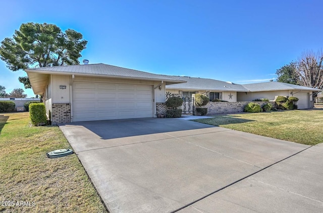 ranch-style house featuring driveway, brick siding, an attached garage, and a front yard