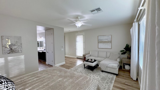 bedroom featuring ensuite bathroom, ceiling fan, and light hardwood / wood-style flooring