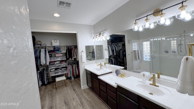 bathroom with vanity, hardwood / wood-style floors, and walk in shower