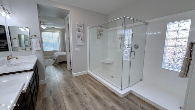 bathroom featuring vanity, hardwood / wood-style floors, ceiling fan, and a shower with shower door