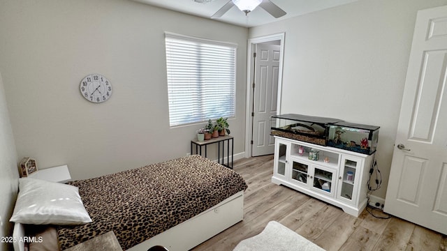 bedroom with ceiling fan and light hardwood / wood-style floors