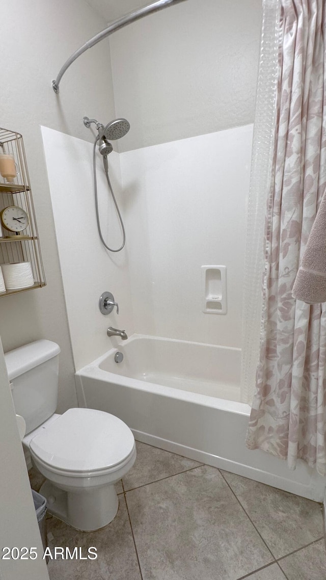 bathroom with tile patterned floors, toilet, and shower / bath combo