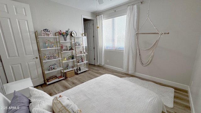 bedroom with ceiling fan and light wood-type flooring