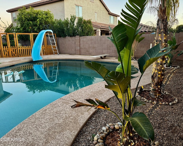 view of swimming pool with a water slide