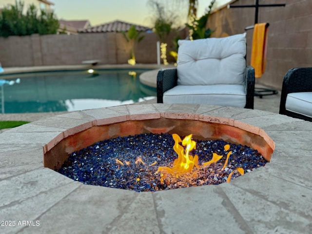 view of swimming pool with an outdoor fire pit