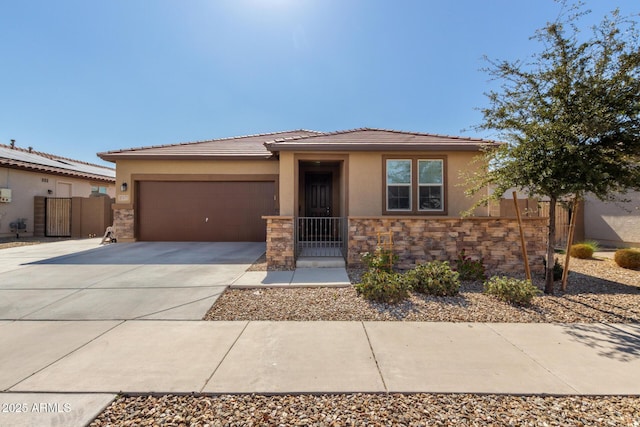 view of front of home with an attached garage, fence, stone siding, concrete driveway, and stucco siding