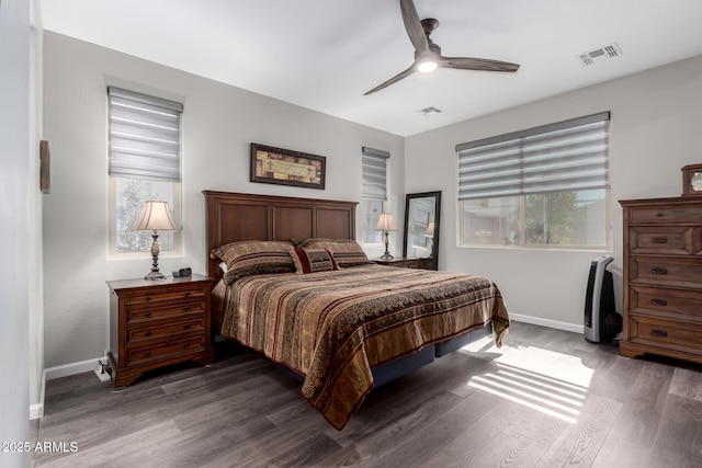 bedroom with multiple windows, wood finished floors, and visible vents