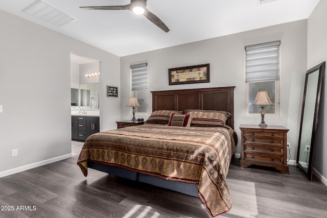 bedroom featuring visible vents, connected bathroom, baseboards, and wood finished floors