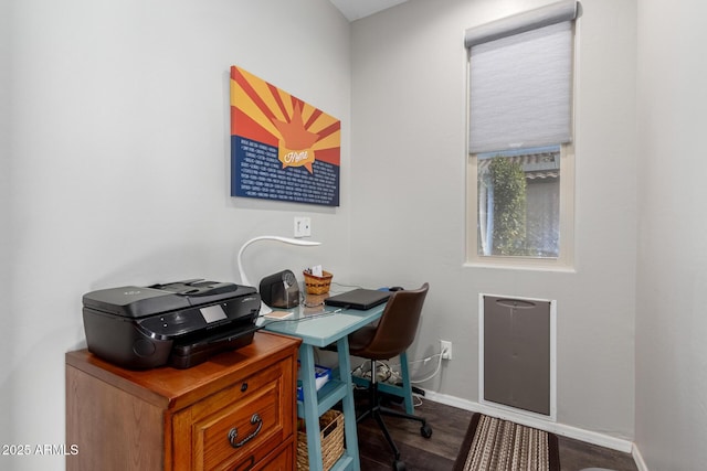 home office with dark wood-style floors and baseboards