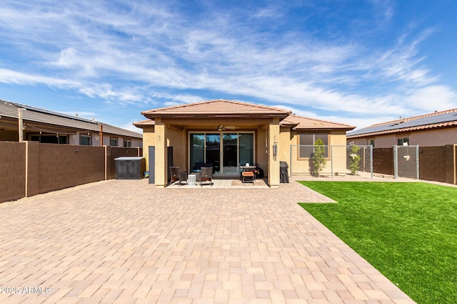 back of property with a patio area, a fenced backyard, a lawn, and stucco siding