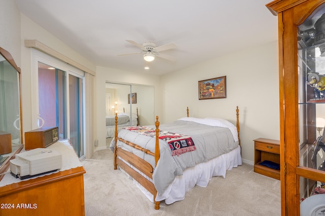 carpeted bedroom featuring ceiling fan and a closet