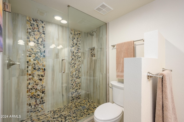 bathroom with walk in shower and toilet