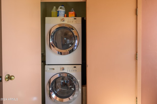 clothes washing area with stacked washer and dryer