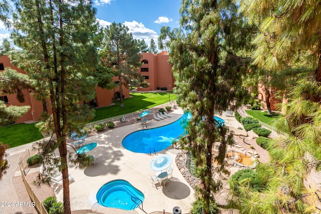 12212 N Paradise Village Pkwy S Unit 451, Phoenix, AZ 85032 - community pool featuring a patio and a yard