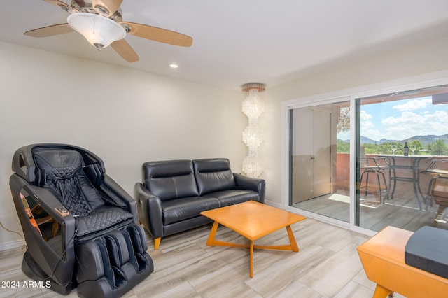 living room with light wood-type flooring and ceiling fan