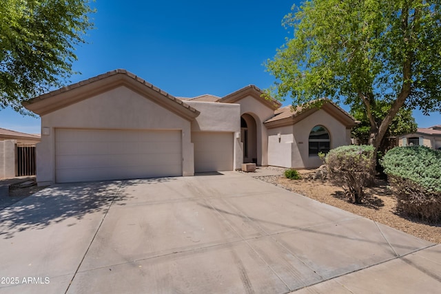14771 W Columbus Ave, Goodyear, AZ 85395 - view of front of home featuring an attached garage, stucco siding, concrete driveway, and a tiled roof