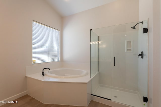 14771 W Columbus Ave, Goodyear, AZ 85395 - bathroom featuring a shower stall, a bath, wood finished floors, and baseboards