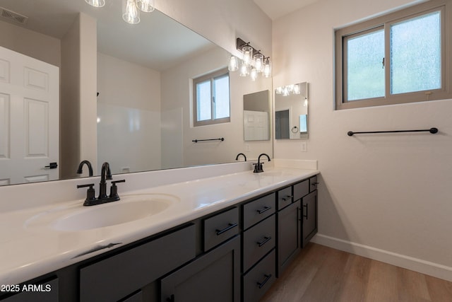 14771 W Columbus Ave, Goodyear, AZ 85395 - full bathroom with wood finished floors, baseboards, and double vanity