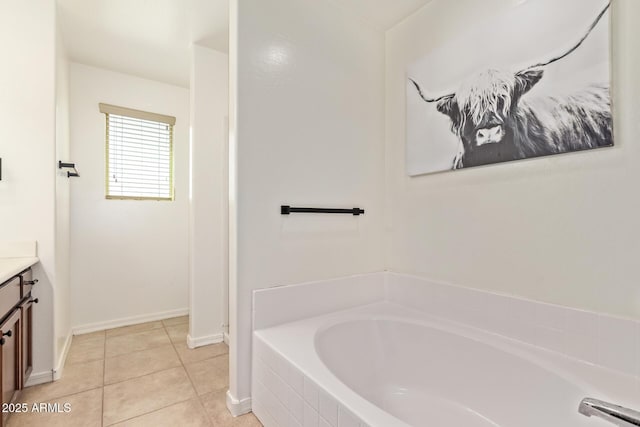 25218 W Carson Ct, Buckeye, AZ 85326 - full bathroom with vanity, a bath, tile patterned flooring, and baseboards