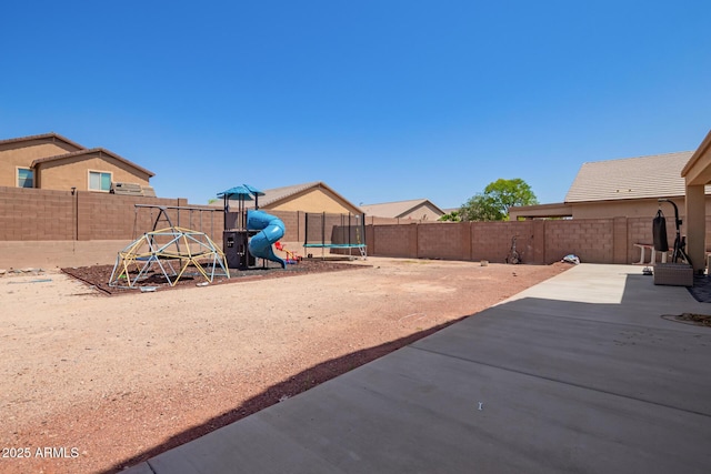 25218 W Carson Ct, Buckeye, AZ 85326 - fenced backyard featuring a trampoline, a patio, and a playground