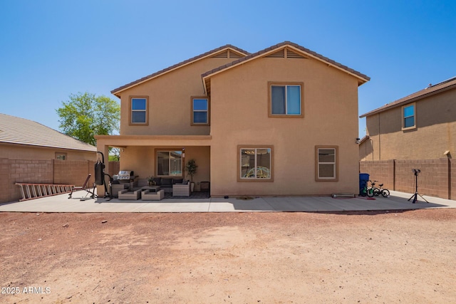 25218 W Carson Ct, Buckeye, AZ 85326 - back of house featuring an outdoor living space, a patio area, a fenced backyard, and stucco siding