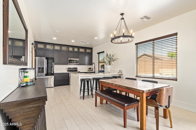 25218 W Carson Ct, Buckeye, AZ 85326 - dining room with a chandelier, recessed lighting, light wood finished floors, and baseboards