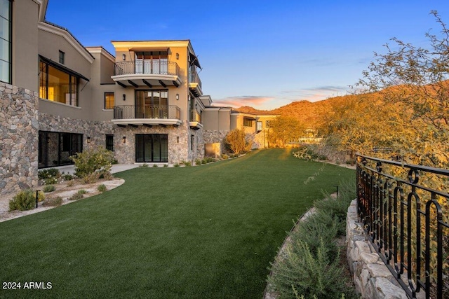 yard at dusk with a balcony