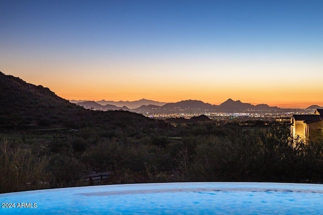 pool at dusk with a mountain view