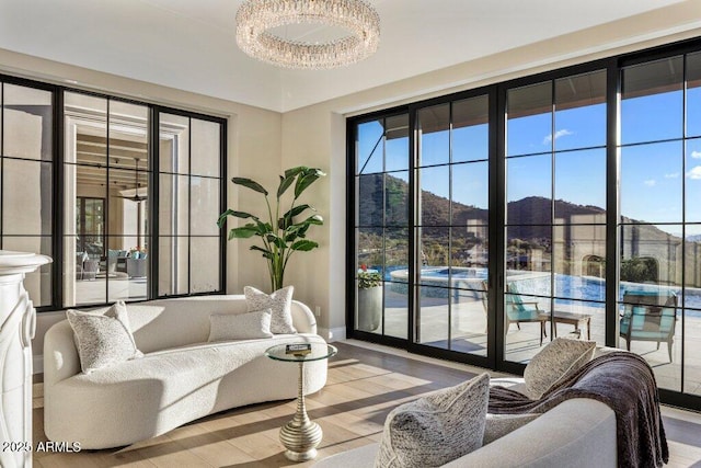 living room featuring a mountain view and light wood-type flooring