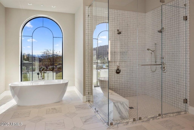 bathroom featuring shower with separate bathtub