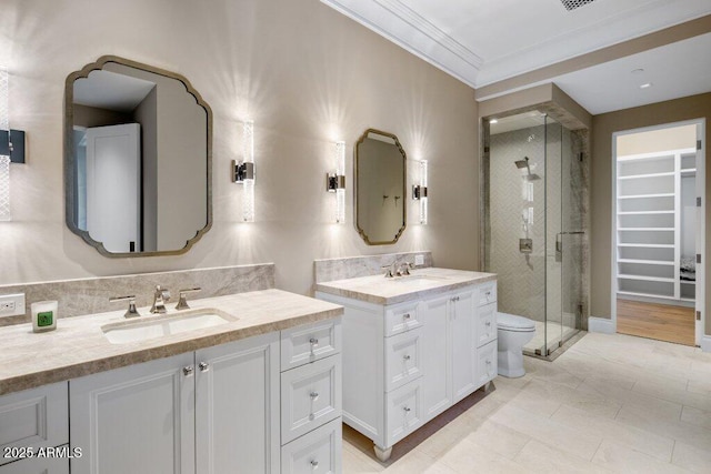 bathroom with vanity, ornamental molding, a shower with shower door, tile patterned floors, and toilet