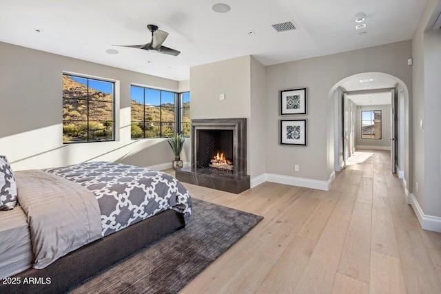 bedroom with ceiling fan and light wood-type flooring