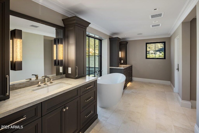 bathroom with vanity, crown molding, and a tub to relax in