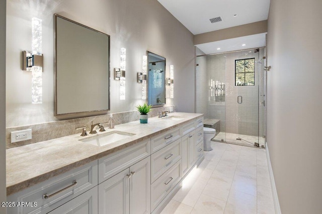 bathroom with vanity, toilet, a shower with shower door, and tile patterned flooring