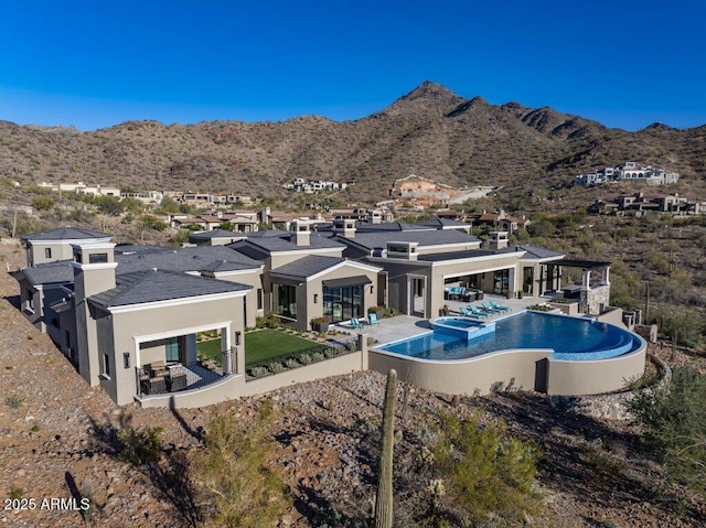 view of pool featuring a mountain view and a patio area