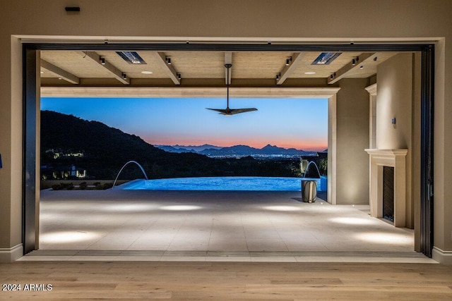 interior space featuring wood-type flooring and a mountain view