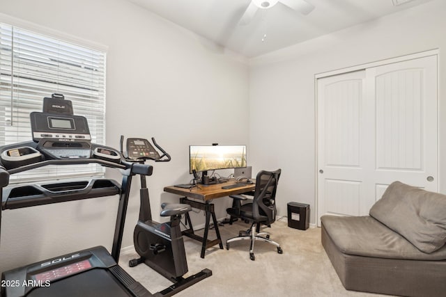 carpeted office space with ceiling fan