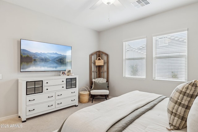 bedroom with visible vents, ceiling fan, light carpet, and baseboards