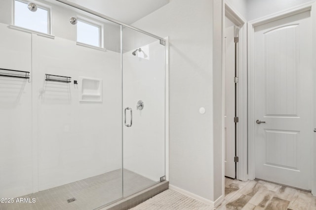 bathroom featuring wood finished floors and a shower stall