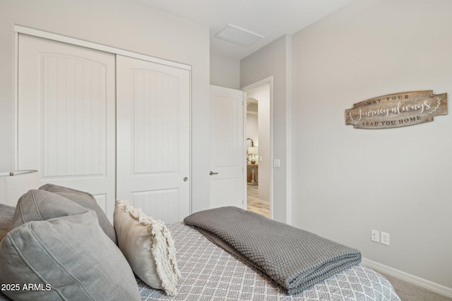 bedroom featuring carpet floors, a closet, visible vents, and baseboards