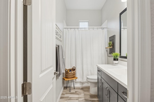 full bath featuring a shower with shower curtain, vanity, toilet, and wood finished floors