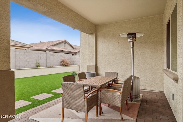 view of patio with fence and outdoor dining space