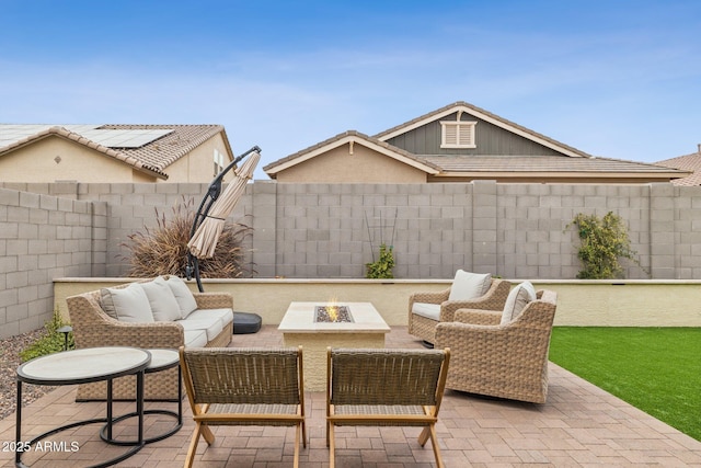 view of patio with an outdoor living space with a fire pit and a fenced backyard