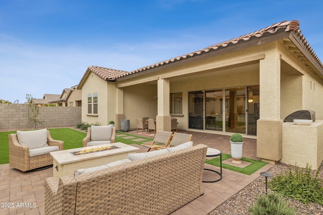 view of patio featuring fence and an outdoor living space with a fire pit