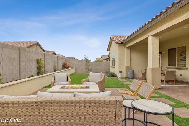 view of patio featuring an outdoor living space with a fire pit and a fenced backyard
