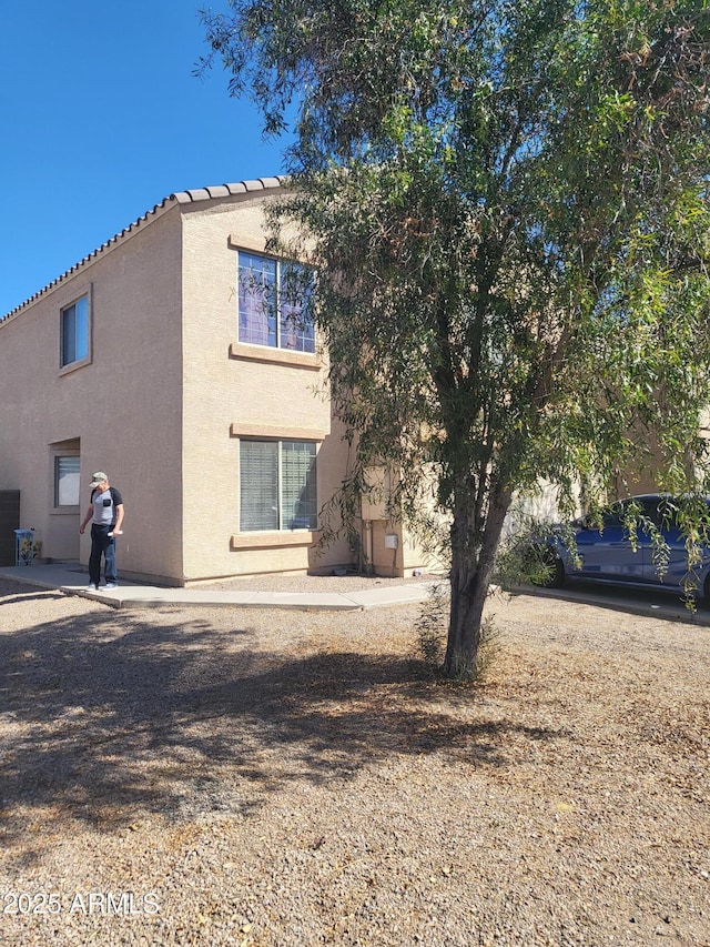 rear view of house with stucco siding